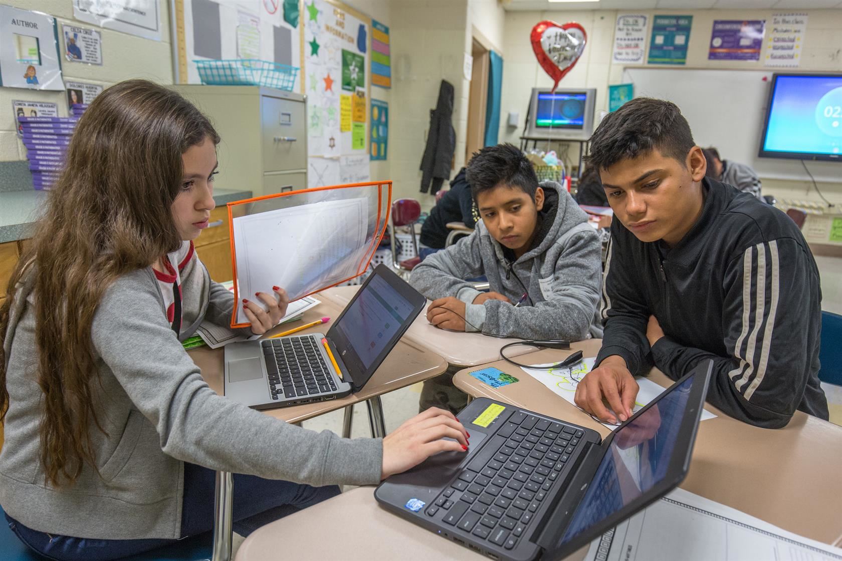 Goal 2 - Grades 3-8 Literacy | Image of children working together on their devices